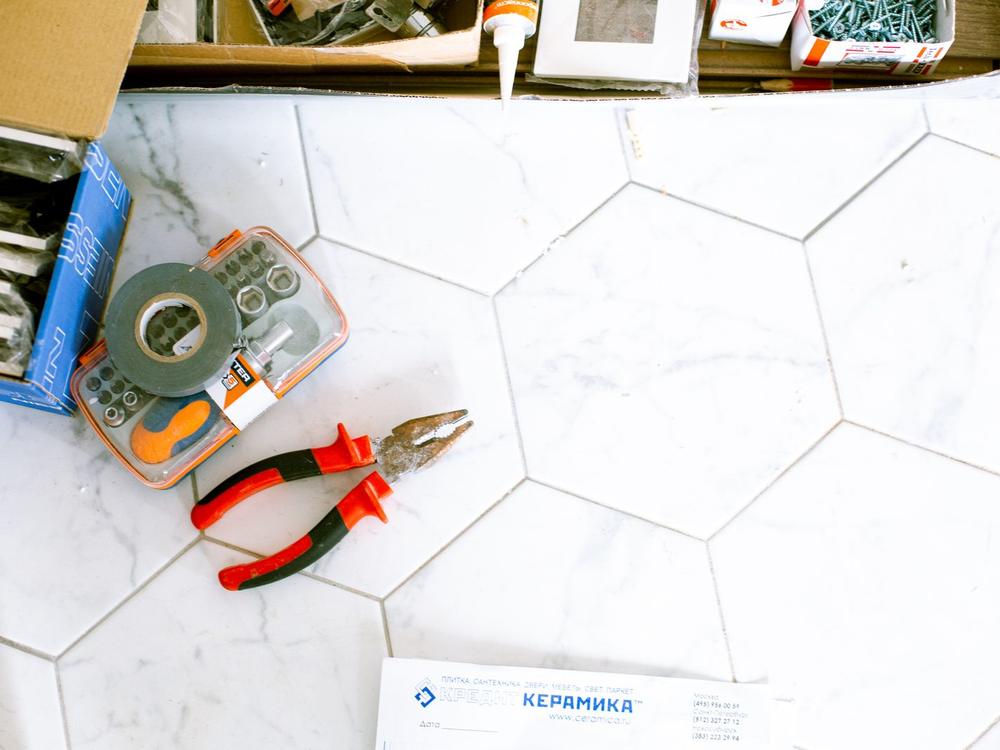 Renovation tools on a tiled floor