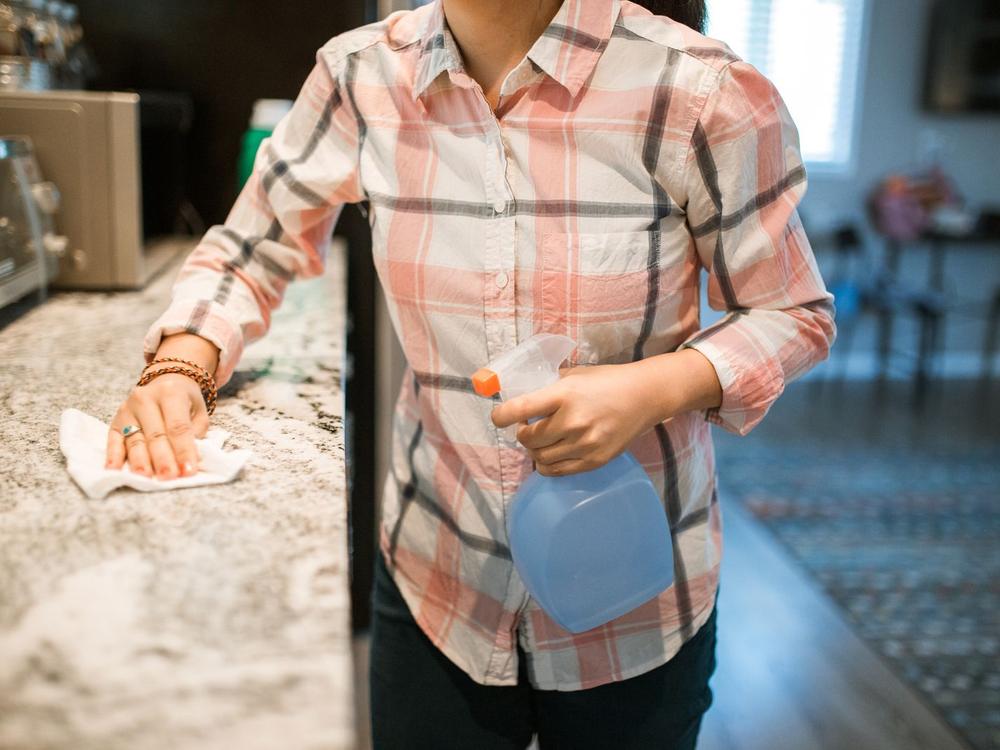 Cleaner wiping a kitchen counter