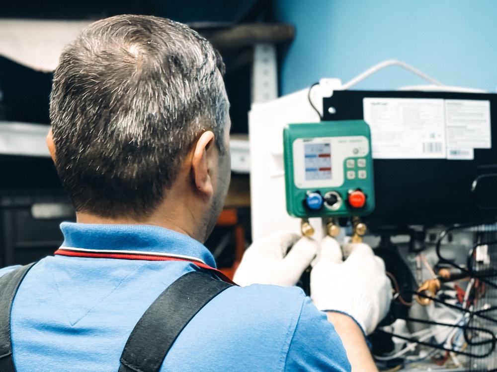 Technician servicing an air conditioner