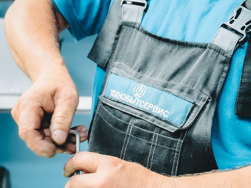 Plumber repairing a pipe with a wrench